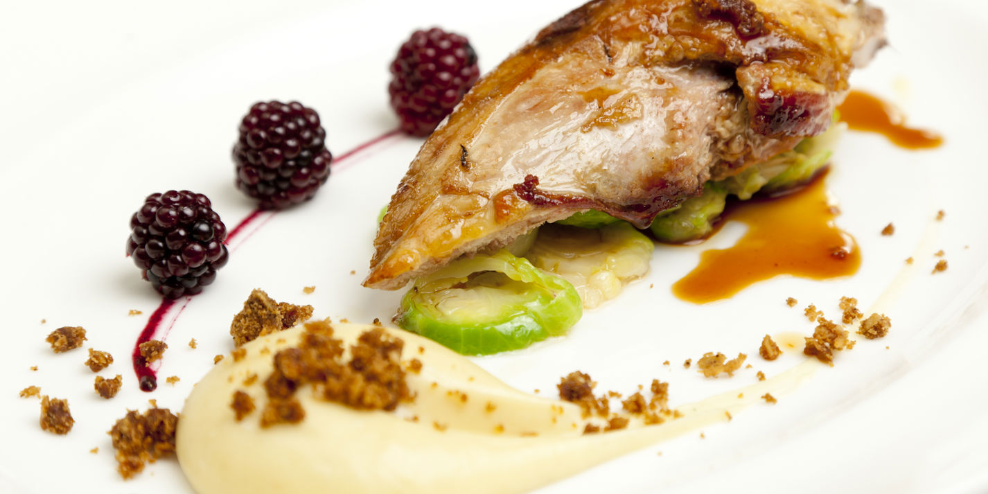Roast pheasant breast with parsnip purée, parkin and pickled brambles