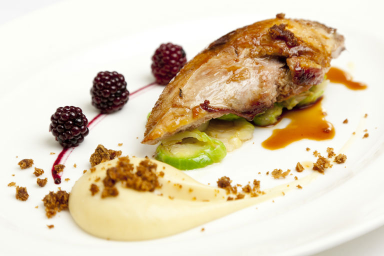 Roast pheasant breast with parsnip purée, parkin and pickled brambles