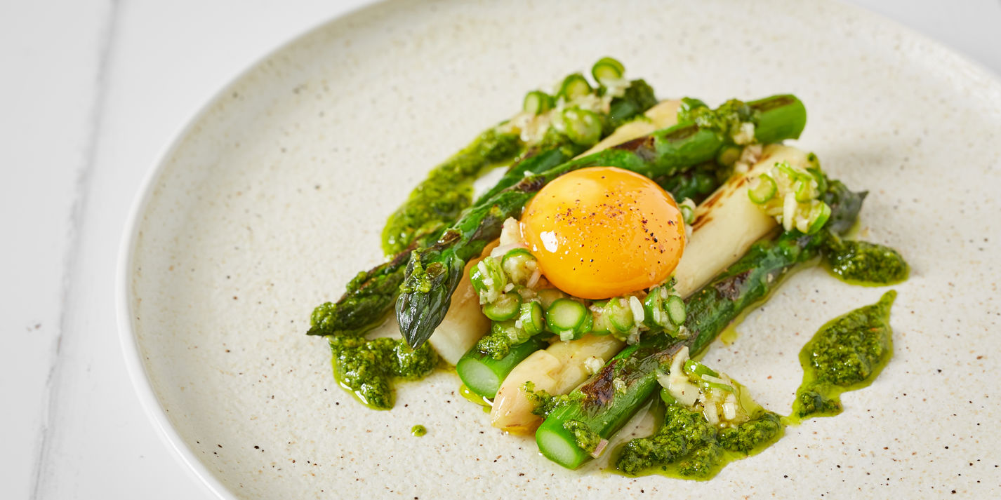 Charred white and green asparagus with pickled egg yolk and pesto