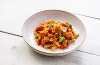 Pesto rosso fusilli with cherry tomatoes and basil