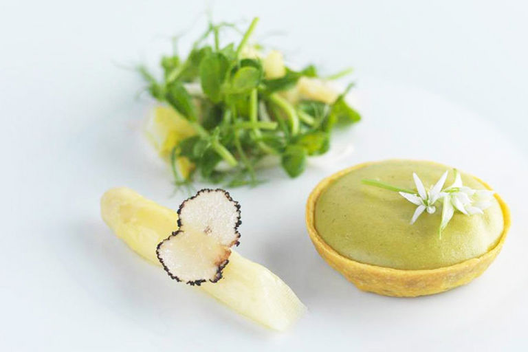 Parmesan and wild garlic tart with lemon, chicory and pea sprouts