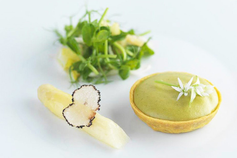 Parmesan and wild garlic tart with lemon, chicory and pea sprouts