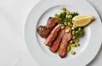 Grilled lamb with braised spinach and broad beans
