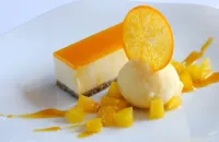 Passion fruit and white chocolate cheesecake with fresh orange sorbet