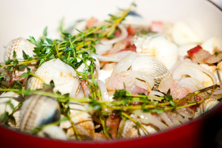 Cockles cooked in white wine with shallots, pancetta and basil