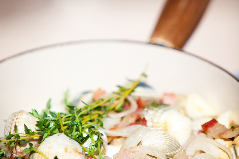 Cockles cooked in white wine with shallots, pancetta and basil