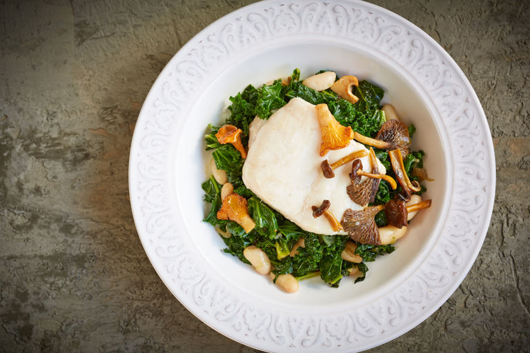 Pan-fried hake with white beans, kale and a sesame and soy dressing
