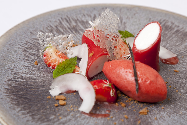 Coconut panna cotta with strawberry gel, strawberry sorbet and cut strawberries