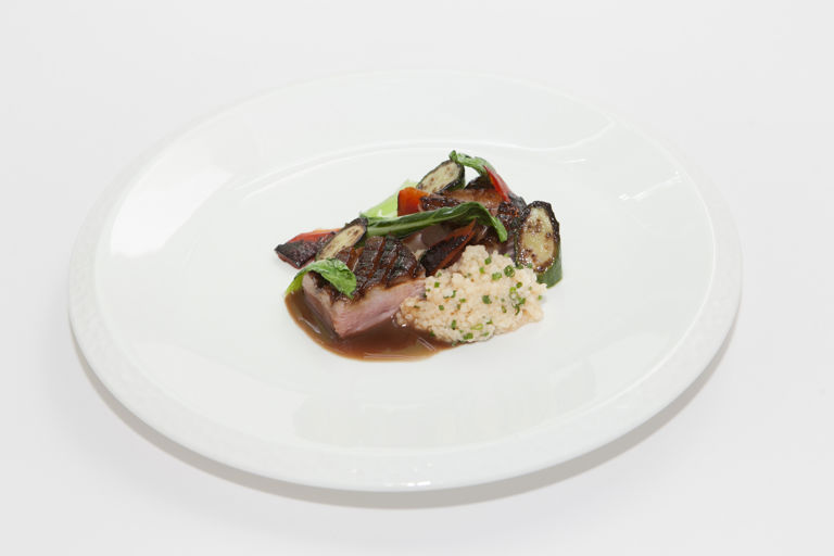 Honey-glazed duck breast, pak choi, baby courgette and tomato couscous