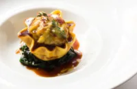 Braised oxtail raviolo with celeriac, sautéed spinach and oxtail jus