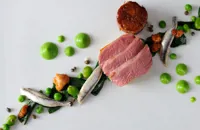 Lamb rump with wild garlic, anchovy and pea purée 