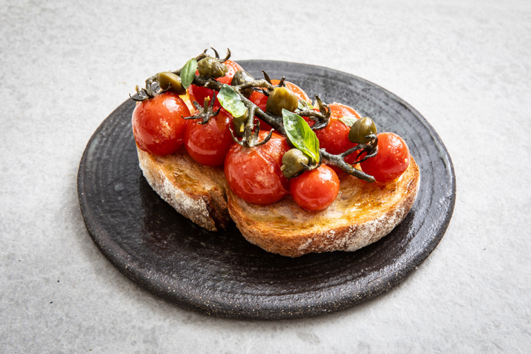 Confit Piccolo tomatoes on toast with anchovies and capers