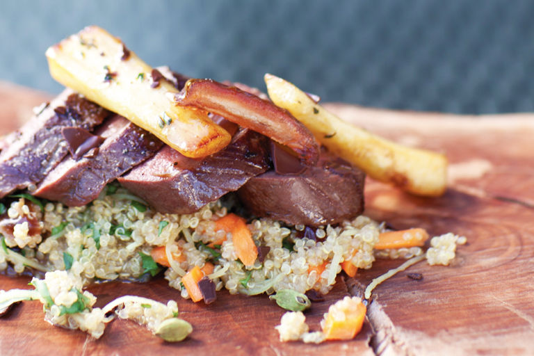 Roast venison loin with parsnips, cardamom-scented quinoa and Medjool dates