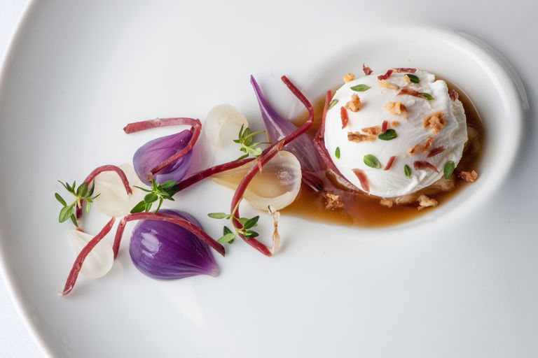 Poached duck egg with roasted onion consommé, lemon thyme and smoked duck 