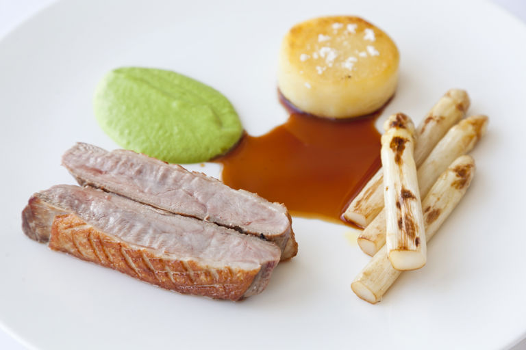 Roast duck breast with white asparagus, pea cream and Meantime beer gravy