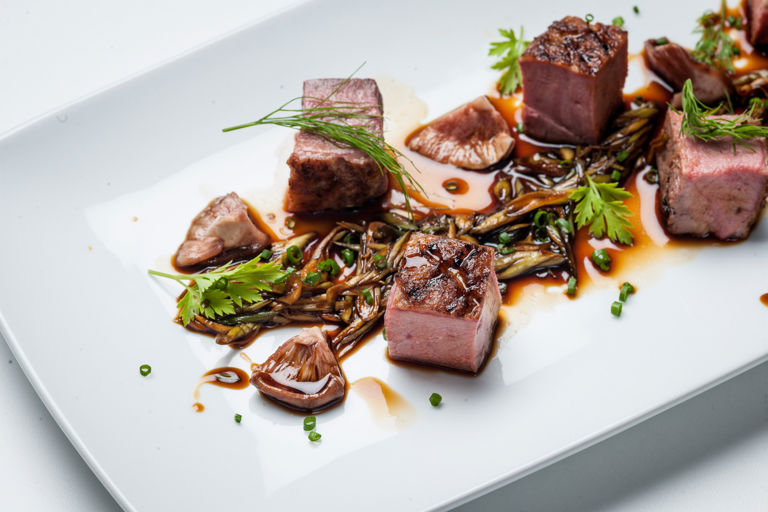 Chargrilled Gressingham duck breast with spring onion, pickled shiitake mushrooms, garden herbs and soy reduction