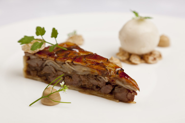 Glazed 'tart' of pig cheeks and penny bun, roasted celeriac, pear sorbet and wild cress