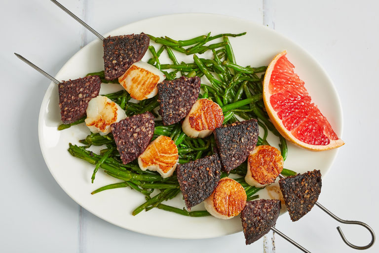 Black pudding and scallop skewers with samphire and pink grapefruit