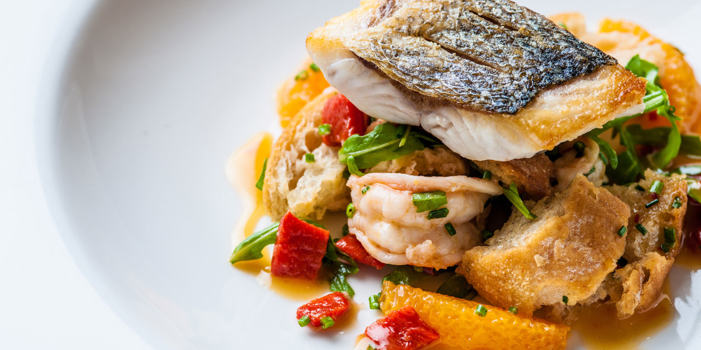 Sea bass and tiger prawn panzanella-style salad with chilli dressing