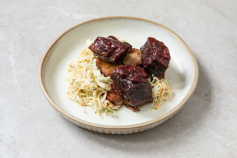 Smoky roasted beef short ribs with blackberry barbecue sauce and fennel coleslaw