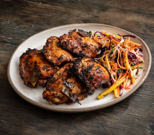 Jerk chicken with mango coleslaw and hot sauce