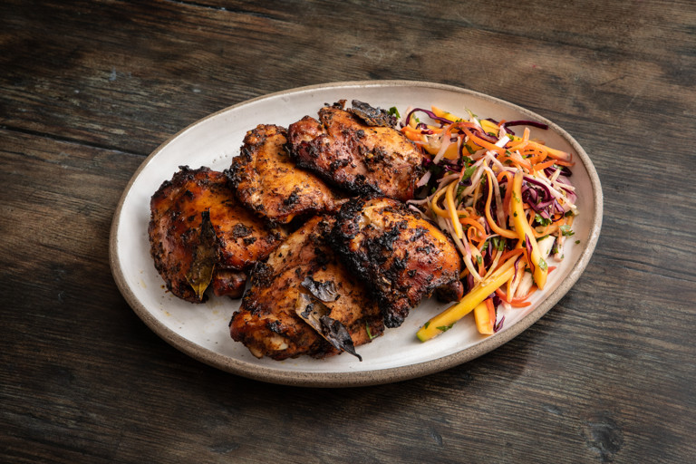 Jerk chicken with mango coleslaw and hot sauce