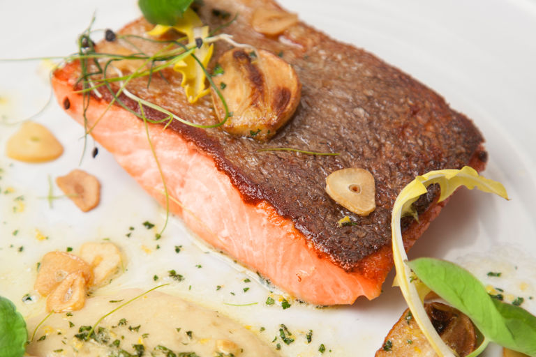 Pan-fried fjord trout with white bean purée and garlic crisps