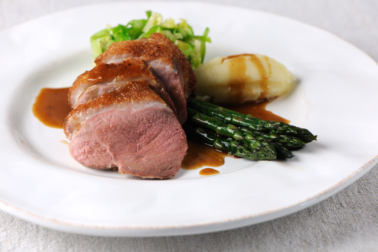 Roast duck breast with asparagus, caramelised shallot and hispi cabbage
