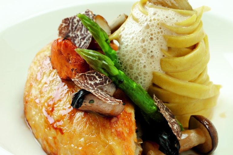 Pot-roasted maize-fed chicken with wild mushrooms, asparagus spears and truffle tagliatelle