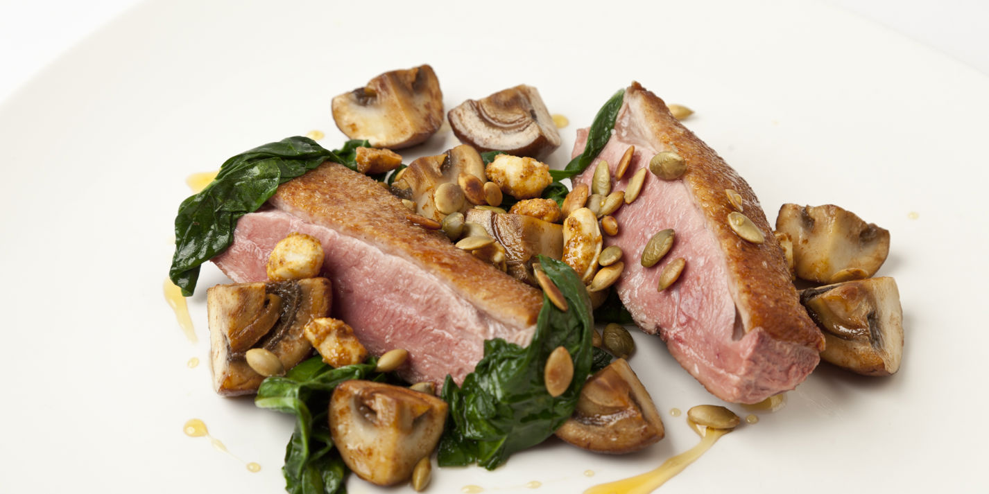 Seared duck breast with sautéed and pickled mushrooms, pumpkin seeds and toasted peanuts
