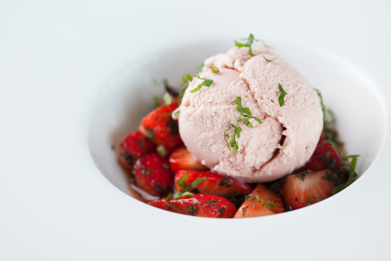 Strawberry ice cream with marinated strawberries and pouring cream
