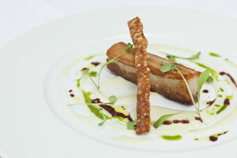Slowly braised belly of pork with apple soup, garlic purée and Port jus