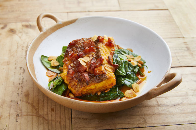 Cod with pimentón, spinach, pine nuts and raisins 
