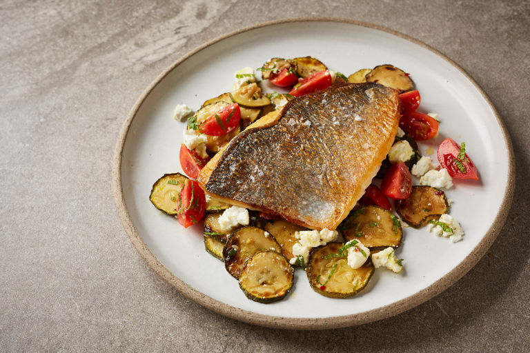 Crispy sea bream fillet with pickled courgettes, cherry tomatoes and feta