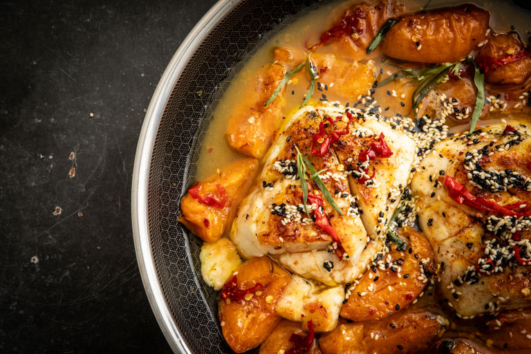 Whole pan-seared and grilled halloumi with apricots, habanero hot honey, sizzling sesame seeds and tarragon 