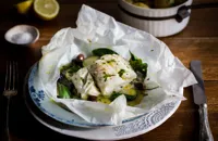 Skrei cod en papillote with olives, spinach and herbs