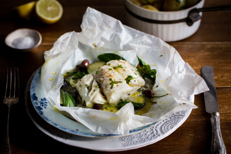 Skrei cod en papillote with olives, spinach and herbs