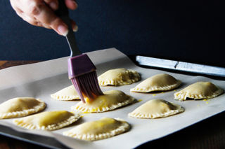Brush the mini pies with the egg mixture