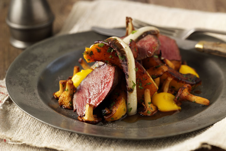 Roast loin of venison with butternut squash, girolles and roast treviso