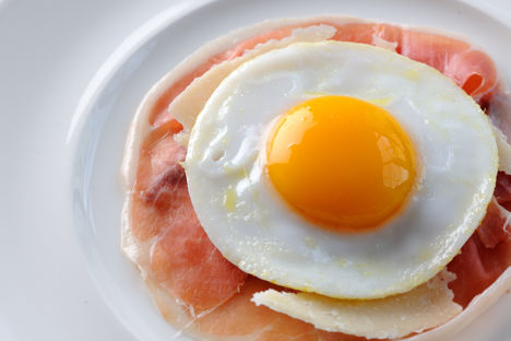 Air-dried ham with a fried duck egg and Parmesan