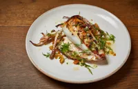 Squid stuffed with breadcrumbs, dried fruits, pine nuts, capers and fennel