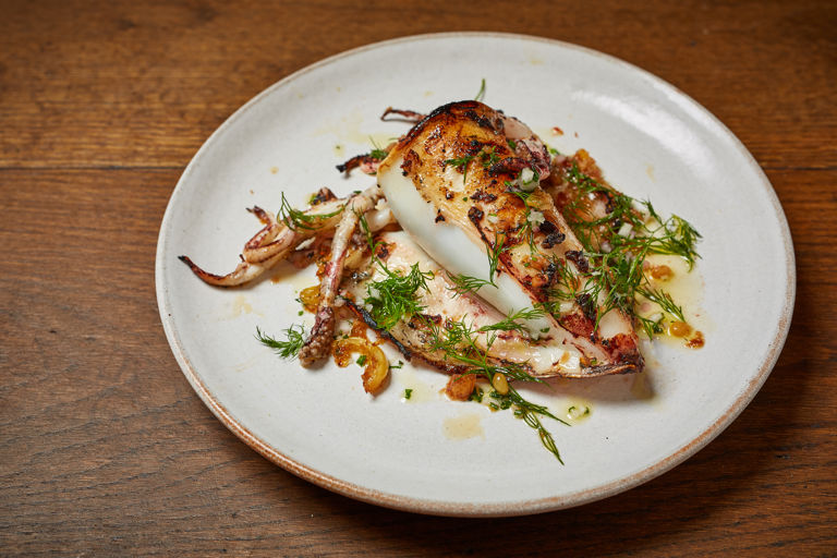 Squid stuffed with breadcrumbs, dried fruits, pine nuts, capers and fennel