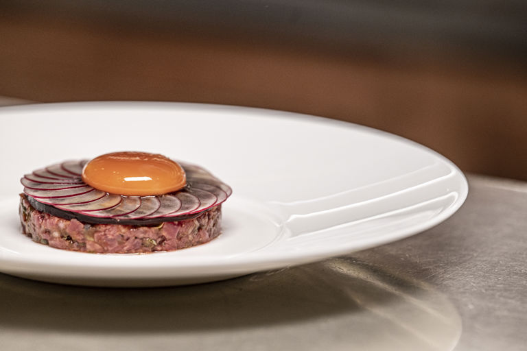 Beef tartare with oxtail jelly, radish and confit egg yolk