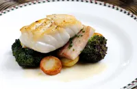 Cod with pork belly, purple sprouting broccoli and lemon butter sauce