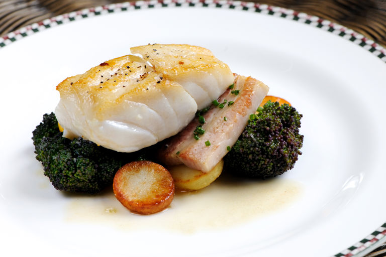 Cod with pork belly, purple sprouting broccoli and lemon butter sauce