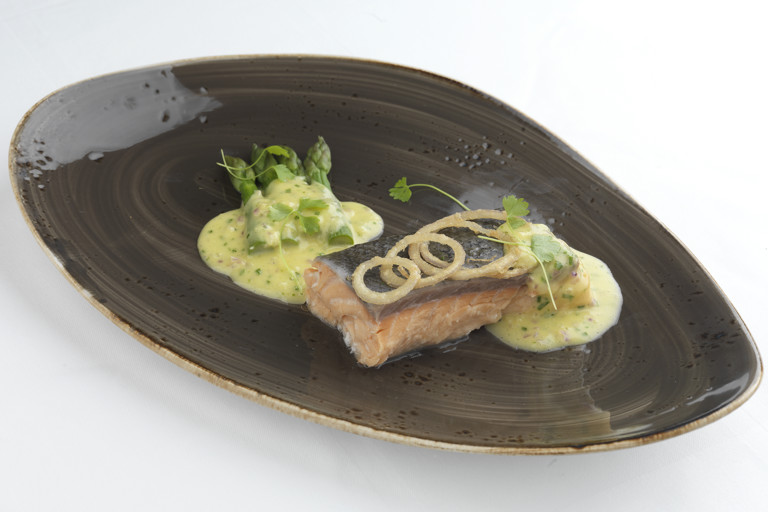 Steamed salmon fillet with asparagus spears and red onion hollandaise