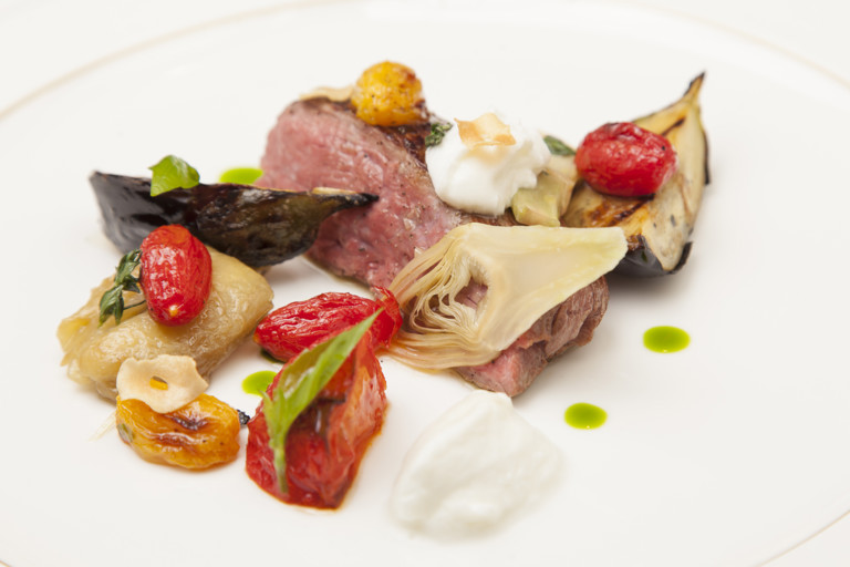 Lamb leg with sheep curd, aubergine caviar, artichoke and roasted tomatoes