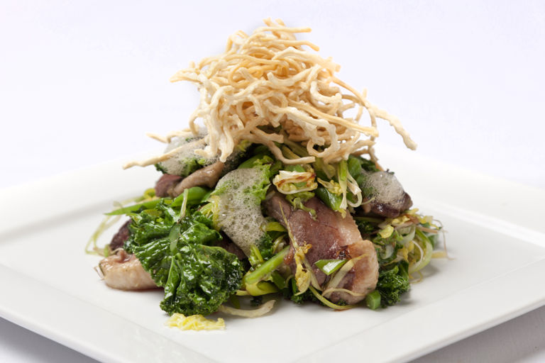 Honey marinated duck breast with sautéed greens and crispy noodles
