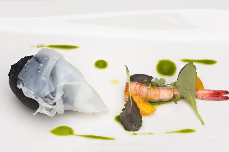 Fried puff of squid ink stuffed with burrata, raw prawn, mandarin and tarragon oil