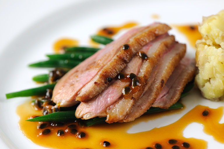 Duck breast with passion fruit sauce and crushed new potatoes